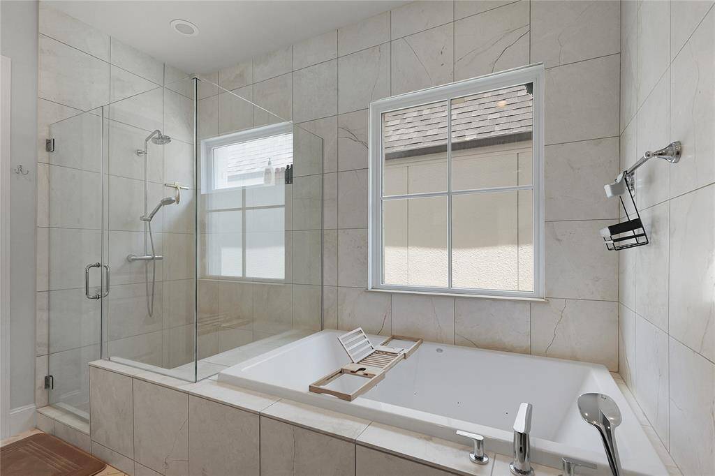Brushed Venetian marble lines your gorgeous glass shower and soaking tub, adjustable shower settings available as well!