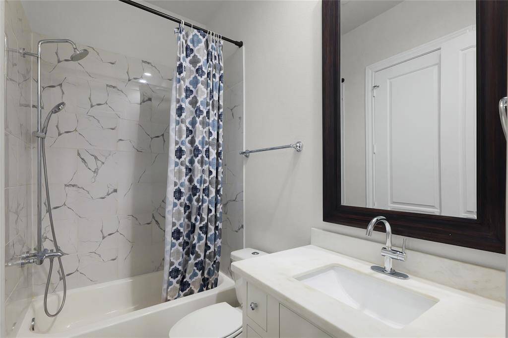 Ensuite bathroom set with Calcutta Bianco tile and imperial white countertops.