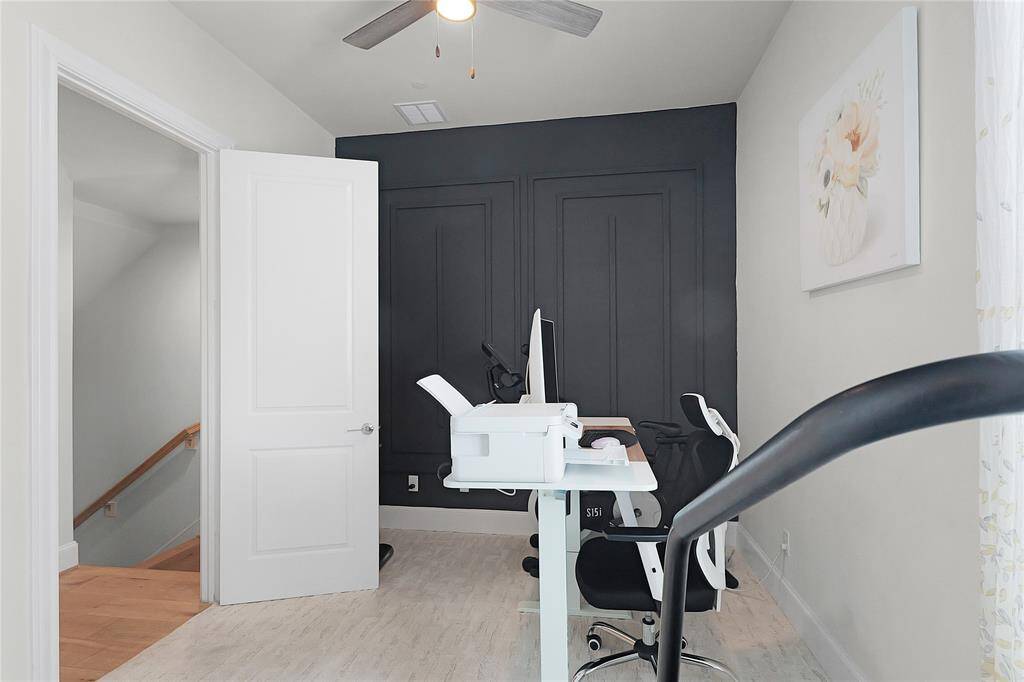 Second-level suite is used as a designated office space with a beautiful accent wall!