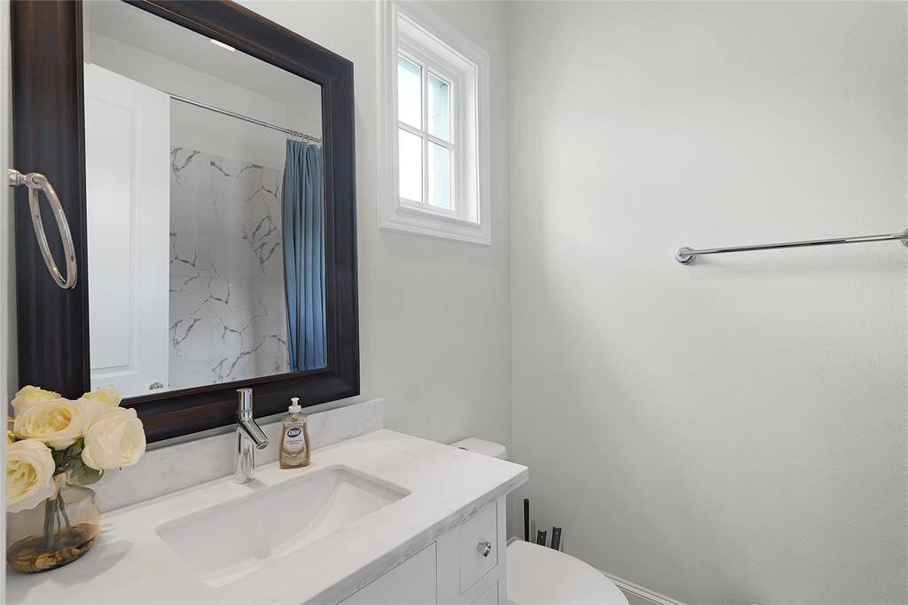 Ensuite bathroom set with Calcutta Bianco tile and imperial white countertops as well.