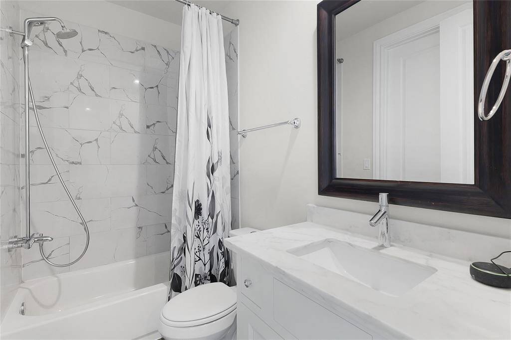 Ensuite bathroom here is also set with Calcutta Bianco tile and imperial white countertops.