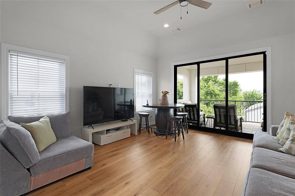 Fourth floor designated game-room space with tall glass doors, can be used as another living space.