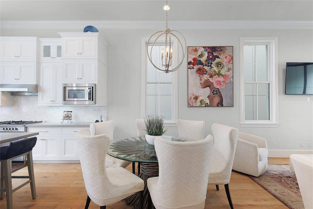 Positioned just off the gourmet kitchen for effortless flow, the space is thoughtfully designed to accommodate a large dining table while maintaining an airy, open feel. Whether you're enjoying candlelit evenings or celebratory gatherings, this dining space offers the perfect blend of ambiance, elegance, and comfort.