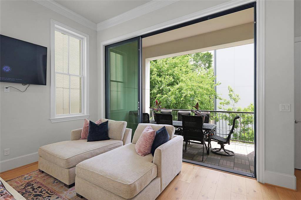 Step into a living space where sophistication meets effortless flow — a stunning open-concept great room that blurs the lines between indoors and out. Anchored by full-height sliding glass panels, the living room opens gracefully onto a private balcony, creating a true extension of the home’s living area.