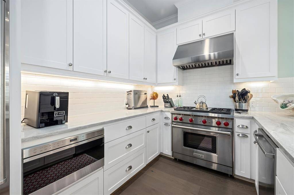 Kitchen features Sub-Zero & Wolf  appliances including a gas range and microwave drawer.