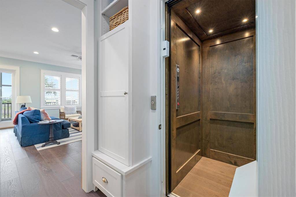 Wood-paneled elevator offers convenient access to all 3 levels of the home.