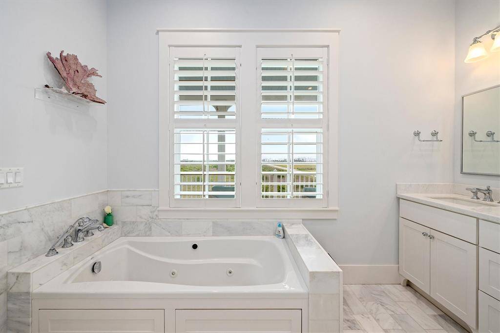 Primary Bathroom also features a whirlpool tub with great views from the adjacent windows.