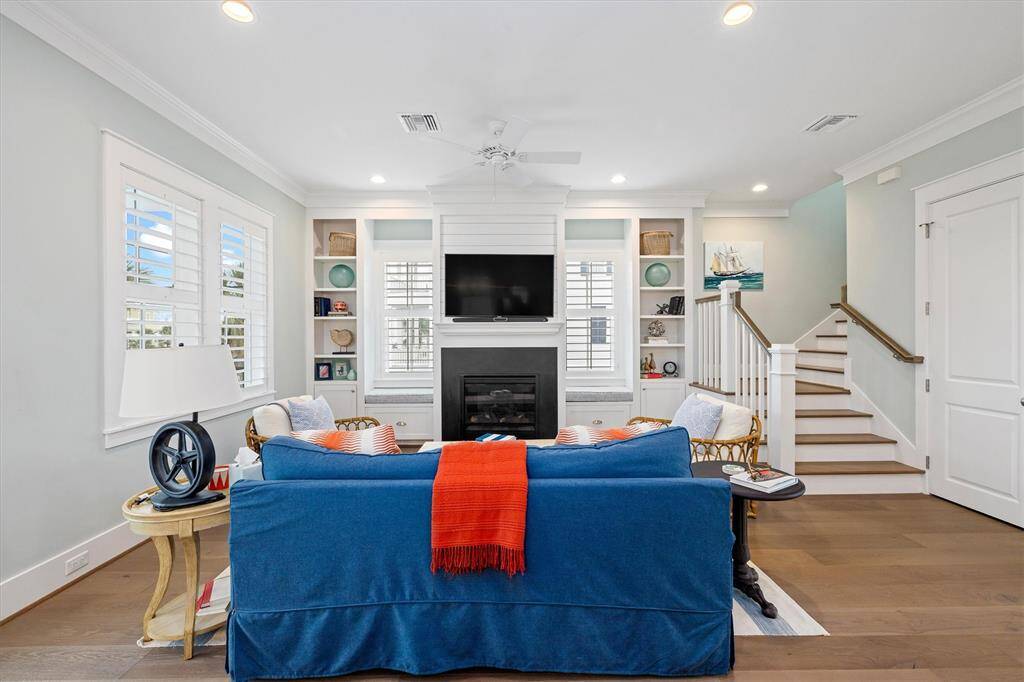 This living room offers a modern coastal vibe and includes a mounted TV, sound bar and subwoofer.