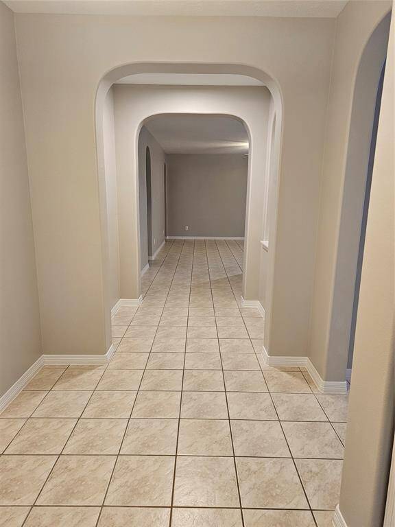 Architectural arches leading to the living room and kitchen.