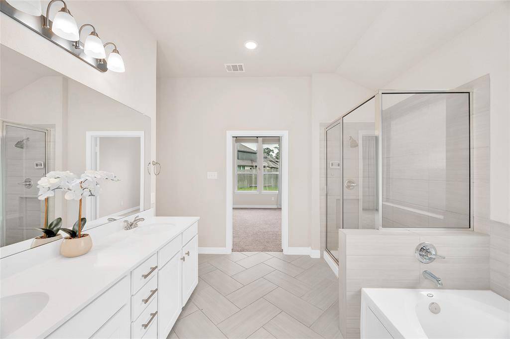 Primary Bathroom with Dual Sinks and Herringbone Tile Floor