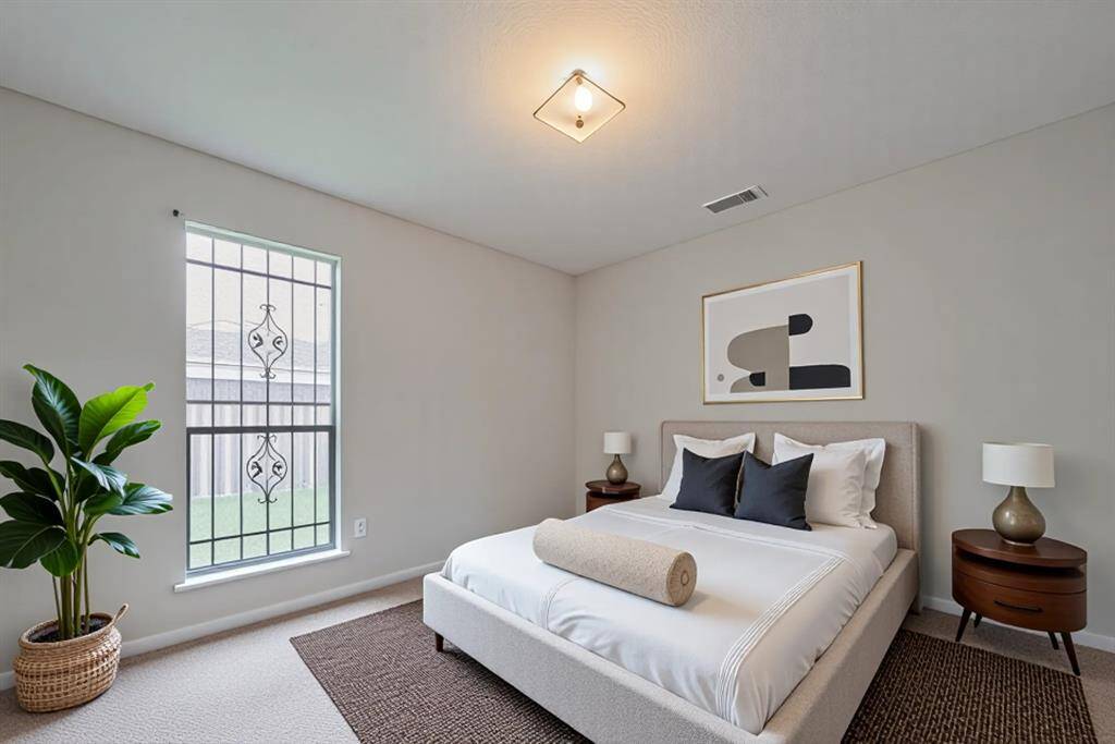 Peaceful Bedroom With Natural LightThis serene bedroom offers plush carpeting, a large window with privacy bars, and a neutral palette—ready for your personal touch.