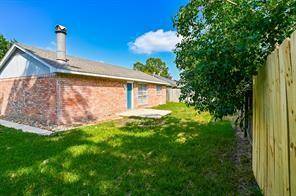 This house is a four sides brick home with a sloped roof and a chimney, set in a grassy yard. This indicates a spacious outdoor space for activities and fun summer days.
