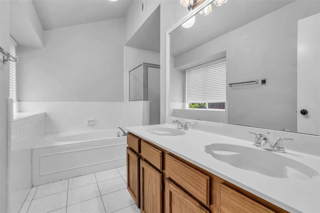 The Primary Bathroom features dual sinks, jetted tub and stand alone shower.  The water closet/toilet is not show in photos.