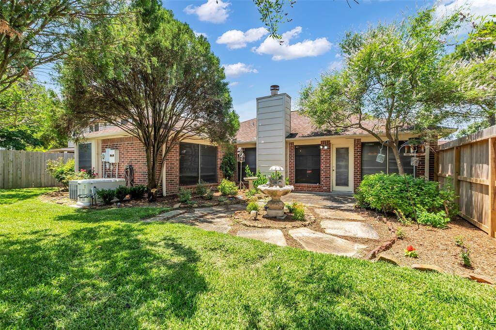 View of the relaxing back courtyard.  There is room in the yard for a play set or an outdoor kitchen.