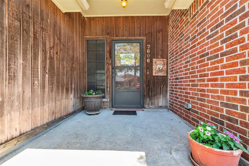 Welcoming covered front porch is so nice on those hot or rainy days. The glass porch door is a bonus!
