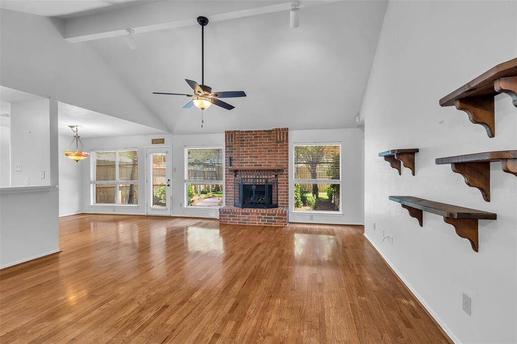 The Family Room has large windows allowing for natural light and wonderful views to the landscaped backyard. The brick fireplace has gas logs.