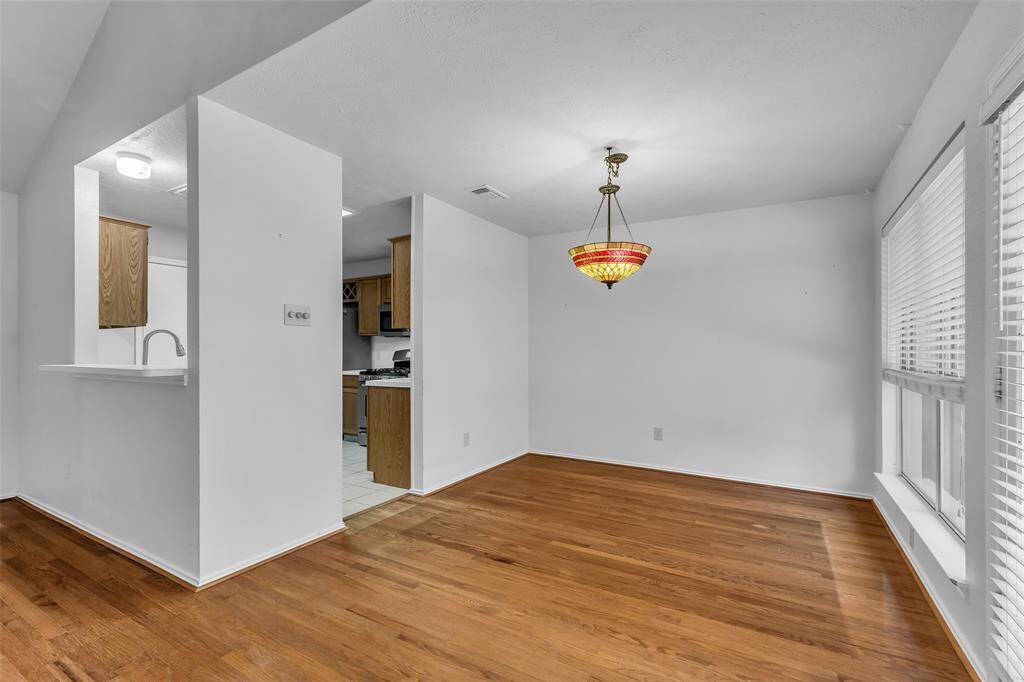 The Breakfast/Dining Room flows with wood flooring into both the Kitchen and Family Room.