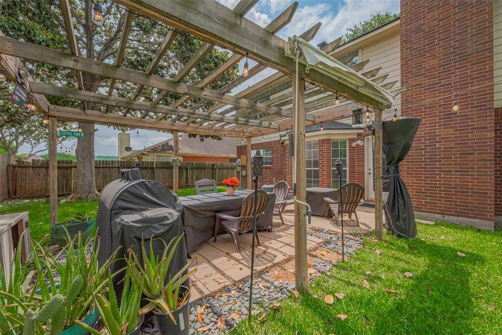 Relax under your charming backyard pergola, perfect for day or night enjoyment.