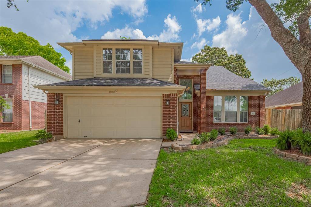 Beautiful two-story brick home with charming curb appeal, spacious two-car garage, and lush landscaped front yard in a quiet, family-friendly neighborhood.