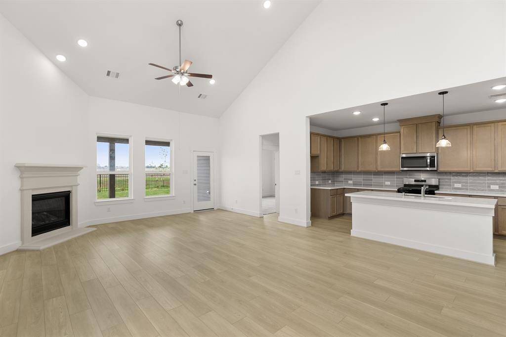 Imagine walking into a home that feels as expansive as it is inviting, bathed in natural light and framed by soaring ceilings that make every moment feel grand.