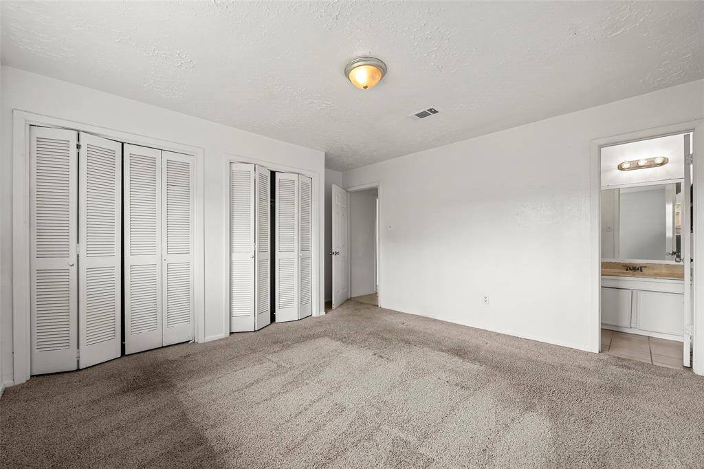 A wall of closets offers great storage in this primary suite!