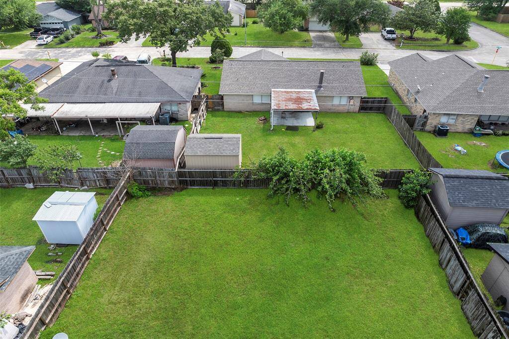 Foliage along the back fence softens the edges!  Do you have dreams of a backyard garden?  There is plenty of room!
