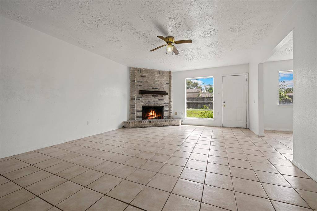Open the door to a light and bright family room with ceramic tile flooring that is so easy to maintain!