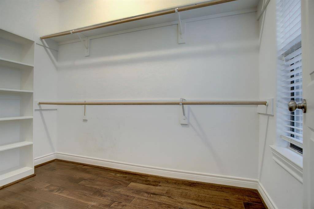 View of one of the two walk in closets in the primary bedroom.