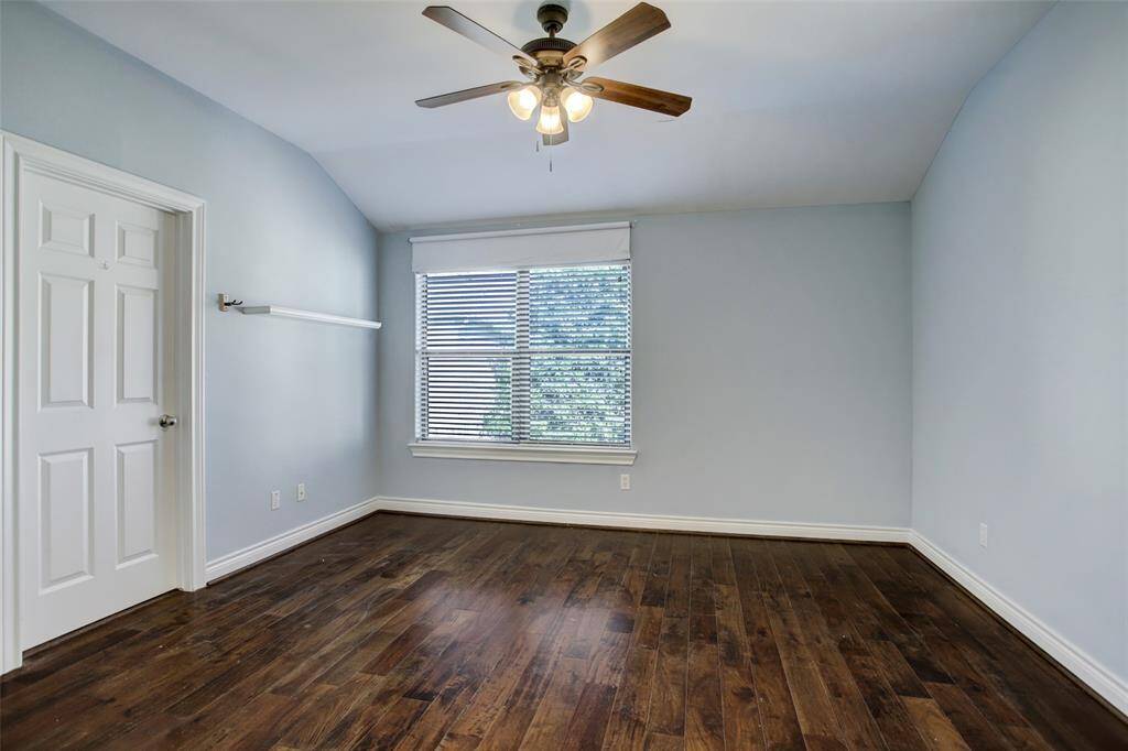 2nd floor ensuite guest bedroom with engineered wood floors. ceiling fan with light.