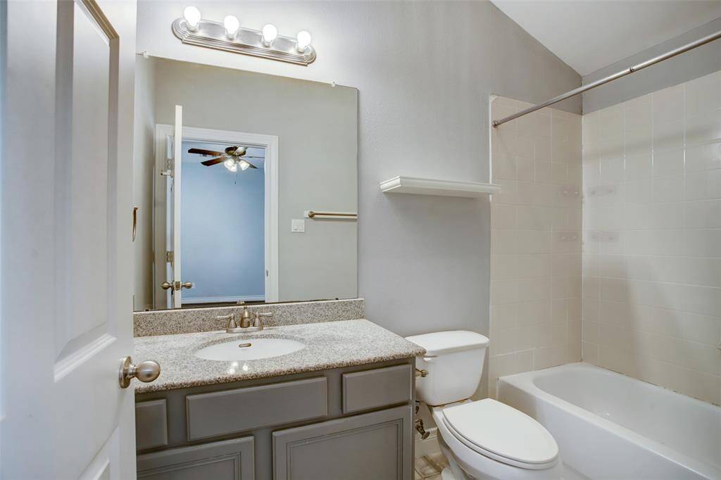 2nd floor ensuite guest bathroom with tub/shower, granite countertops and a designer faucet.