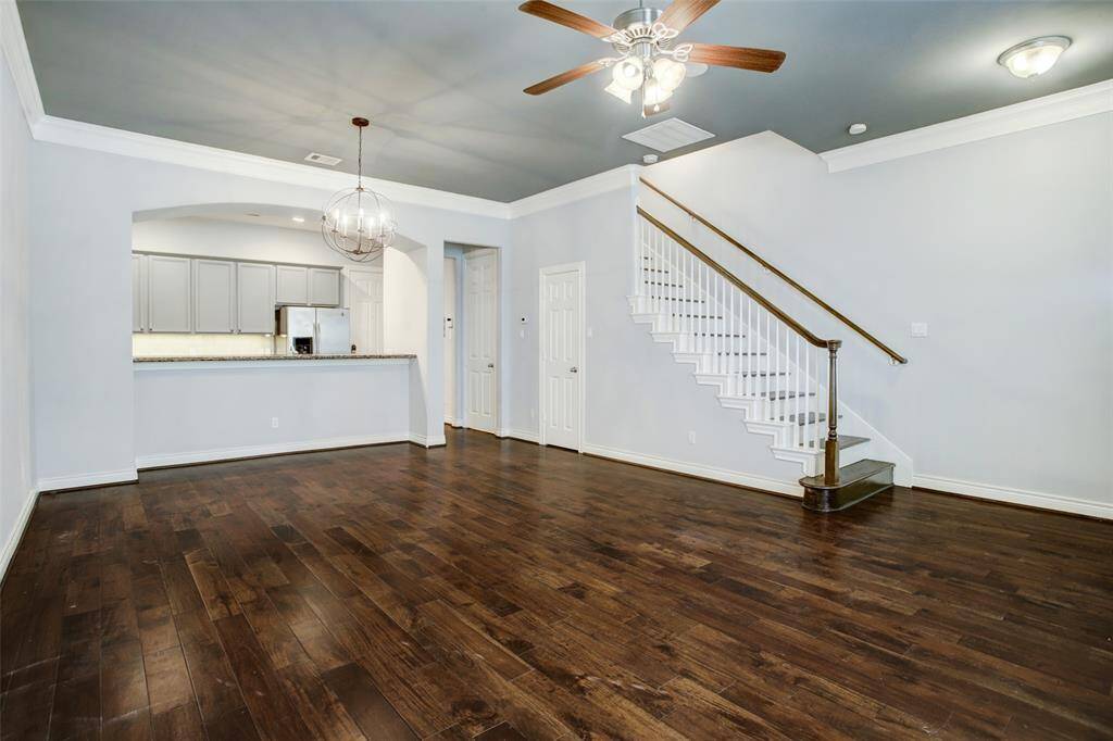 Living room view looking towards the back of the home.  Storage closet under the stairs. Gest 1/2 bath.