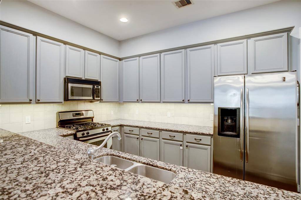 Granite Kitchen with stainless steel appliances.