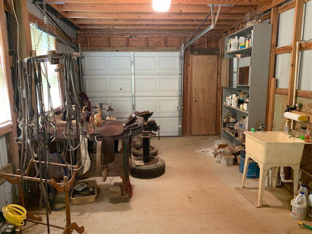 Tack Room w/ overhed door and entry to stables/barn.