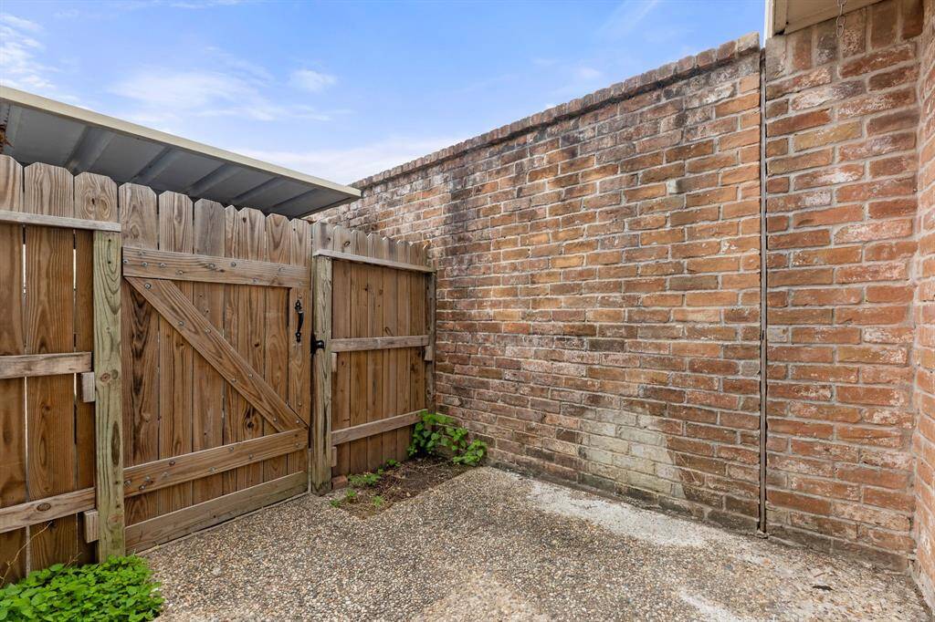 Patio has a brick wall and fence