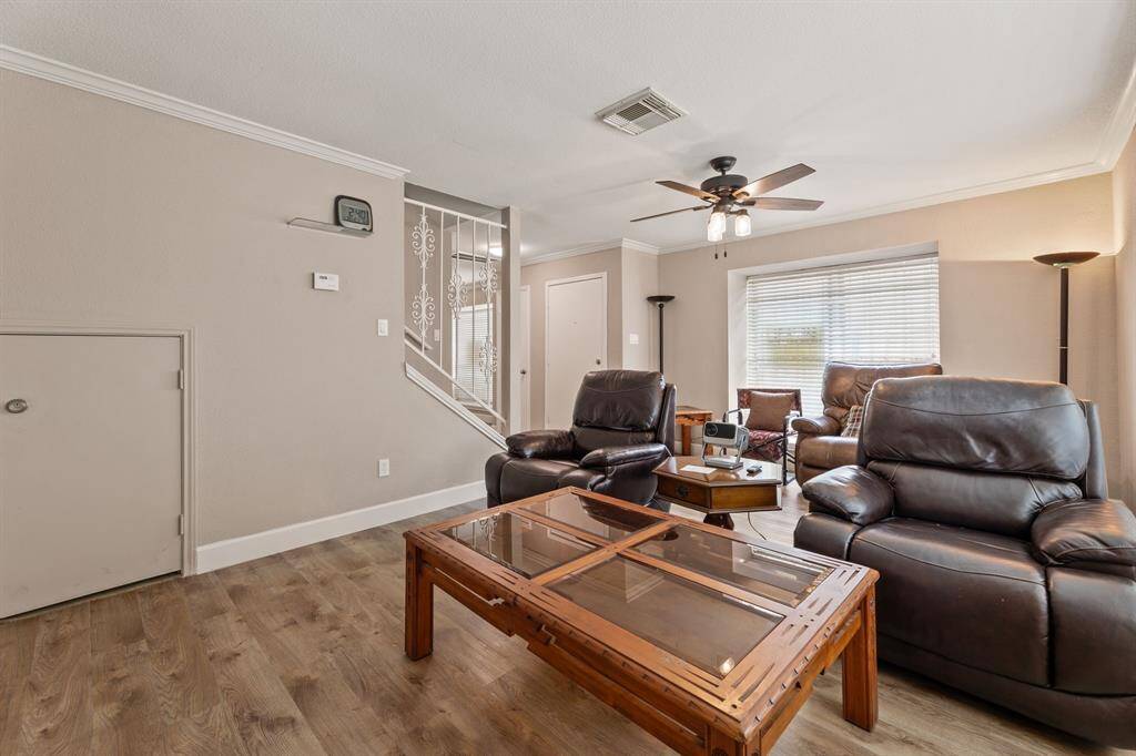 Storage under the stairs in the living room, crown molding