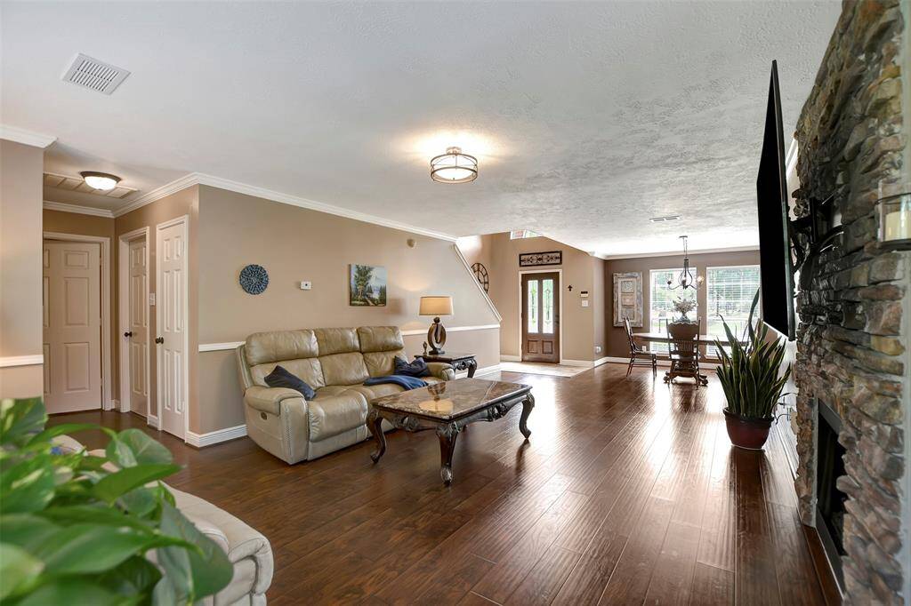 The living room seamlessly flows into a dining area near the entrance.