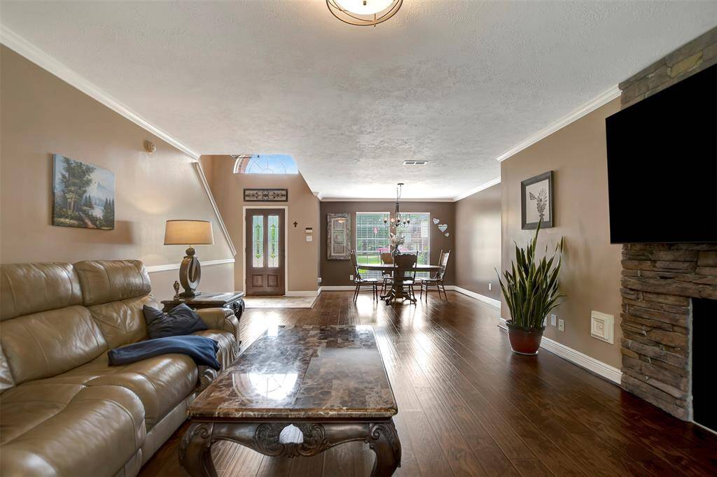 The open layout connects the living room to a dining area, perfect for entertaining.
