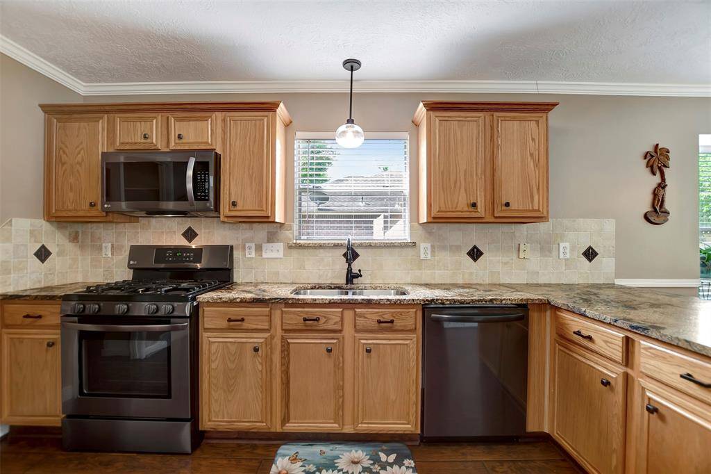Lots of cabinets & counterspace in the kitchen. A window above the sink provides natural light.