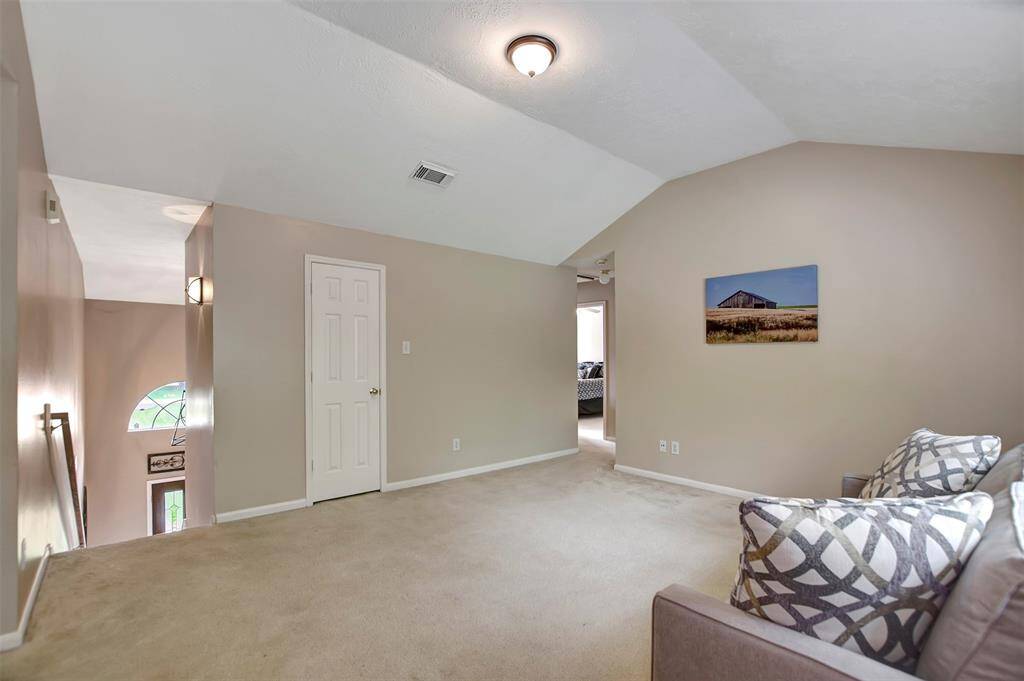 Behind the closed door is a huge walk-in closet with a clothes rack and built-in shelves. Perfect for office supplies or toy storage.