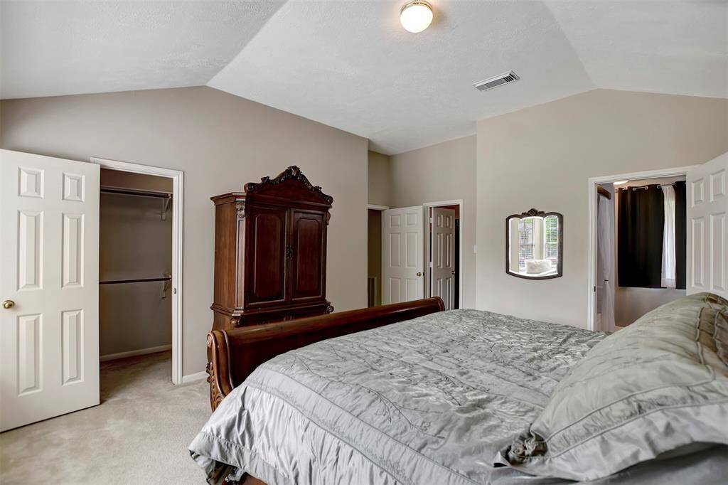 Primary bedroom features 2 walk-in closets, (7x7 w/ built-in shelves & 11.5x4)
