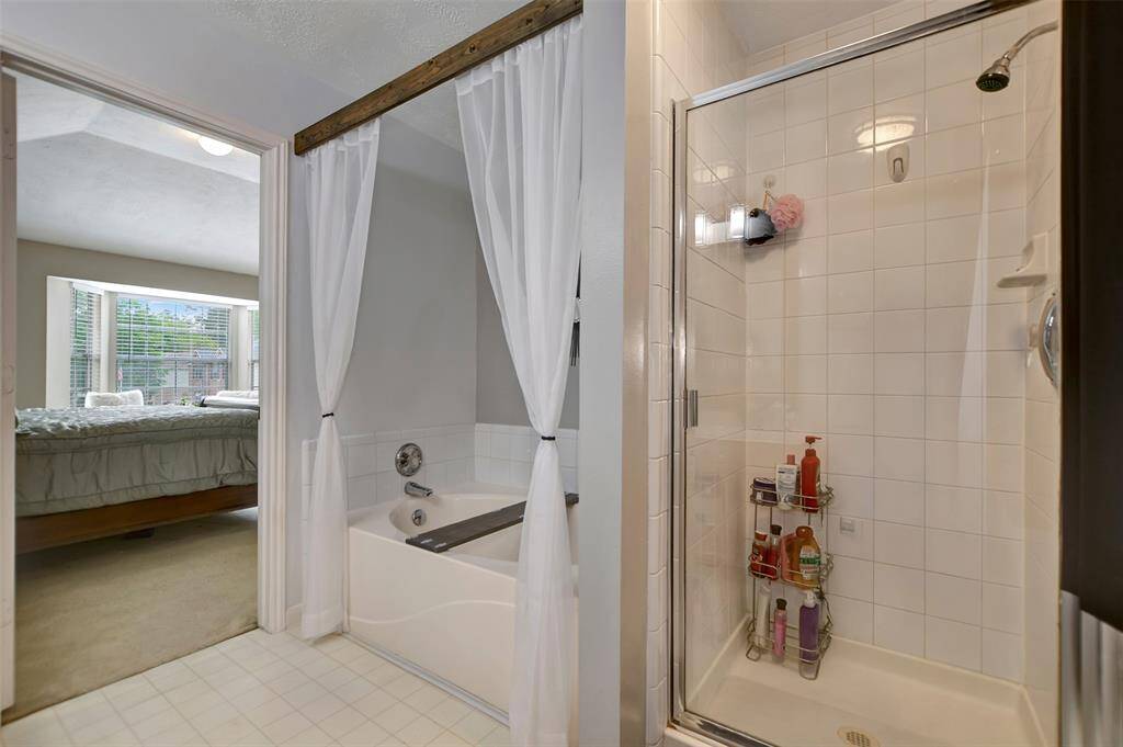 The separate shower and soaking tub in the primary bathroom.