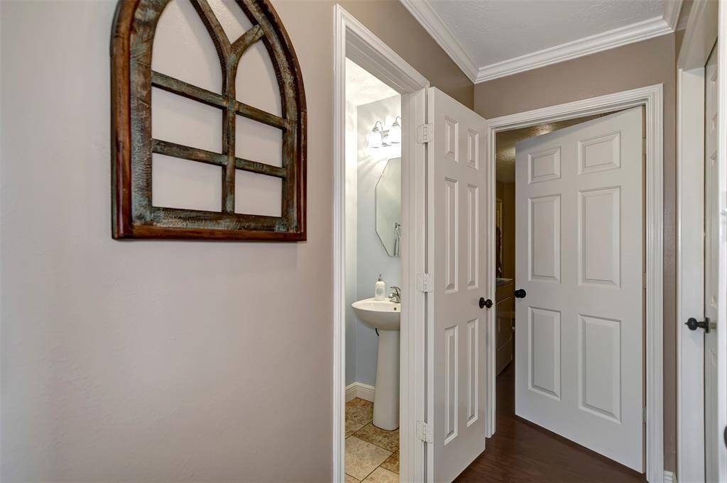 Hallway from the living room leading to the 1/2 bath and laundry room.