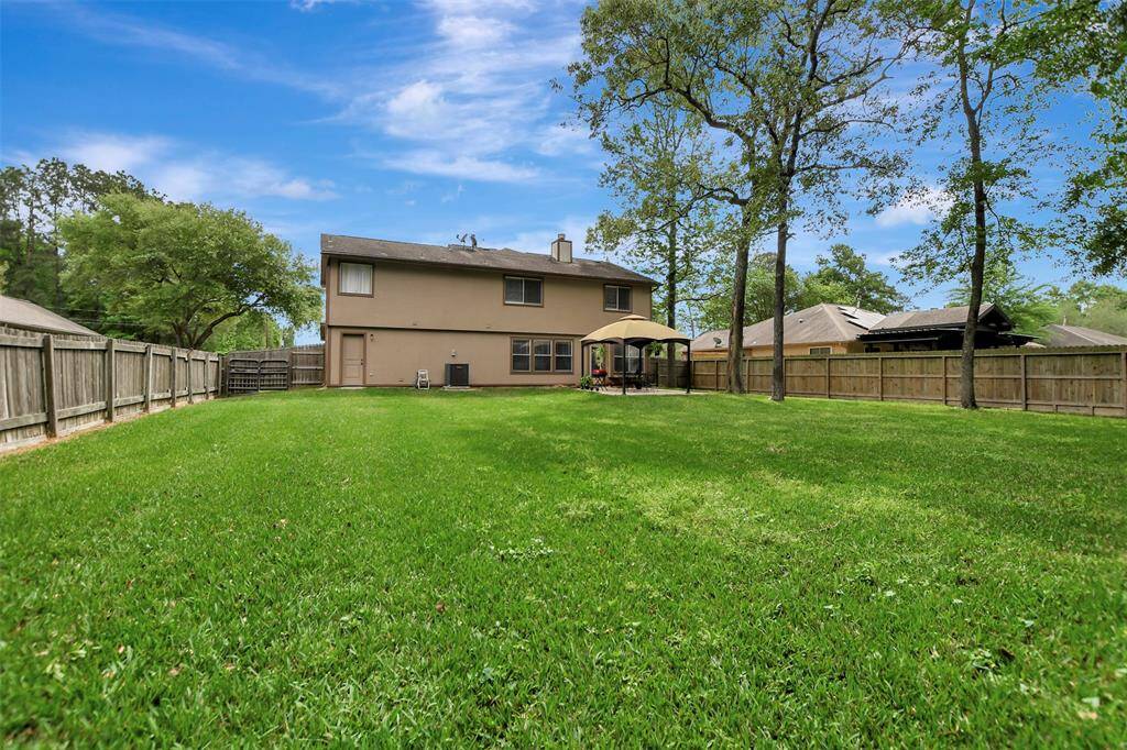 Expansive backyard is perfect for a pool, especially with a door leading into the utility room which is conveniently located by the 1/2 bath.