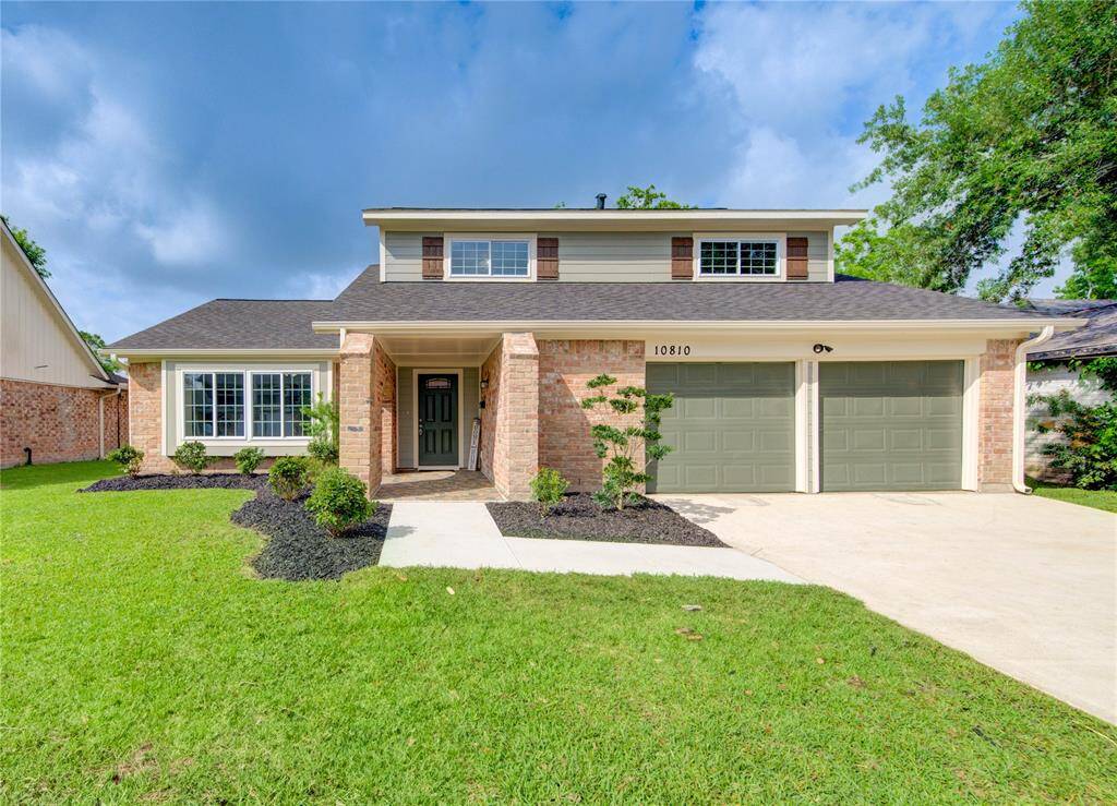 Welcome home! Want beauty and charm with a clean, modern exterior? That's what you'll get with this beautiful, meticulously-remodeled, two-story home! It features a brick facade, a double garage, and a well-manicured lawn with simple, yet captivating, landscaping. The home has large windows and a welcoming front entrance.