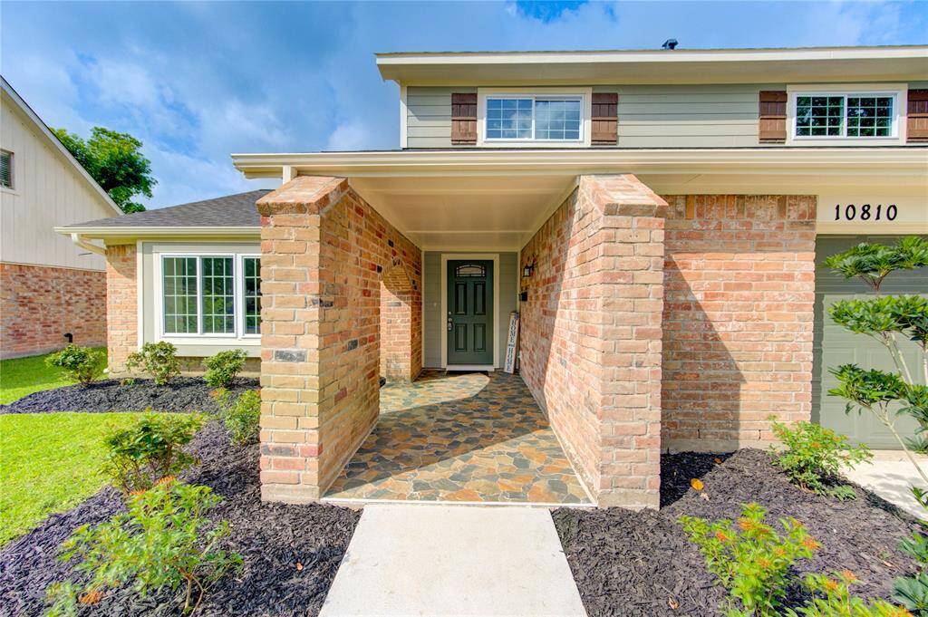 Check out the charming brick exterior with a covered front porch and a slate-tiled entryway. Perfect for rockers.