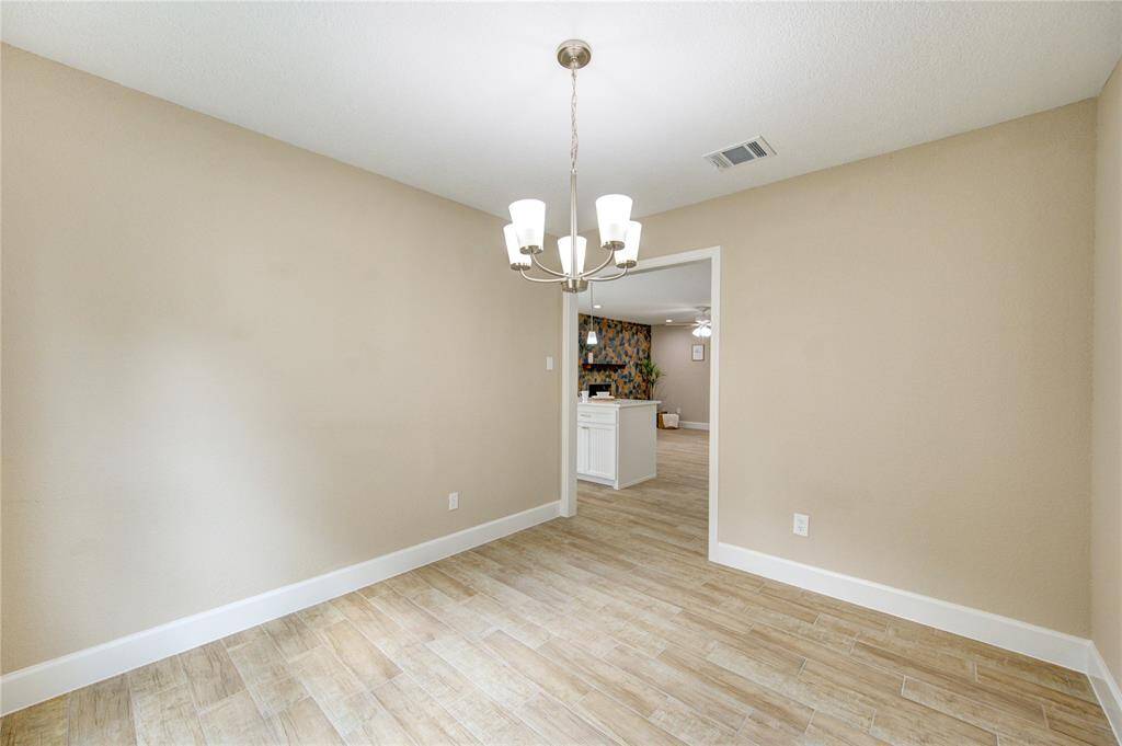Charming dinning room to the left of the entryway that opens up to the kitchen area.