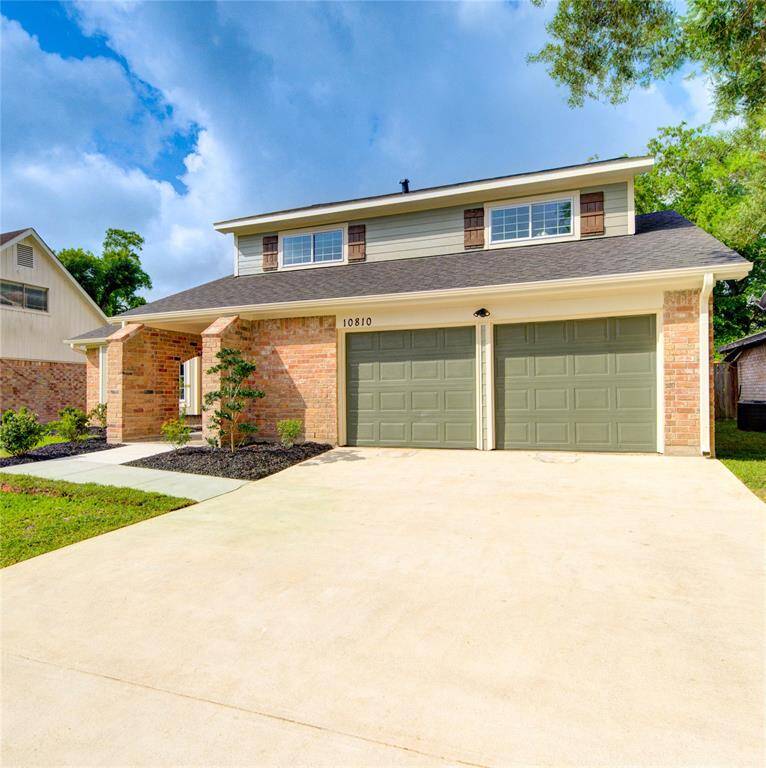 The house has a modern yet classic look, with large windows for natural light. Don't forget to notice the recently poured concrete driveway and walkway.