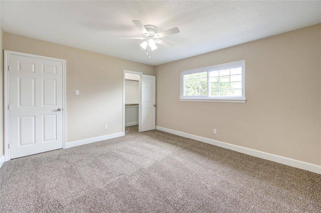 This is bedroom #2 - it's spacious, bright,  and includes a convenient walk-in closet with custom built shelving.
