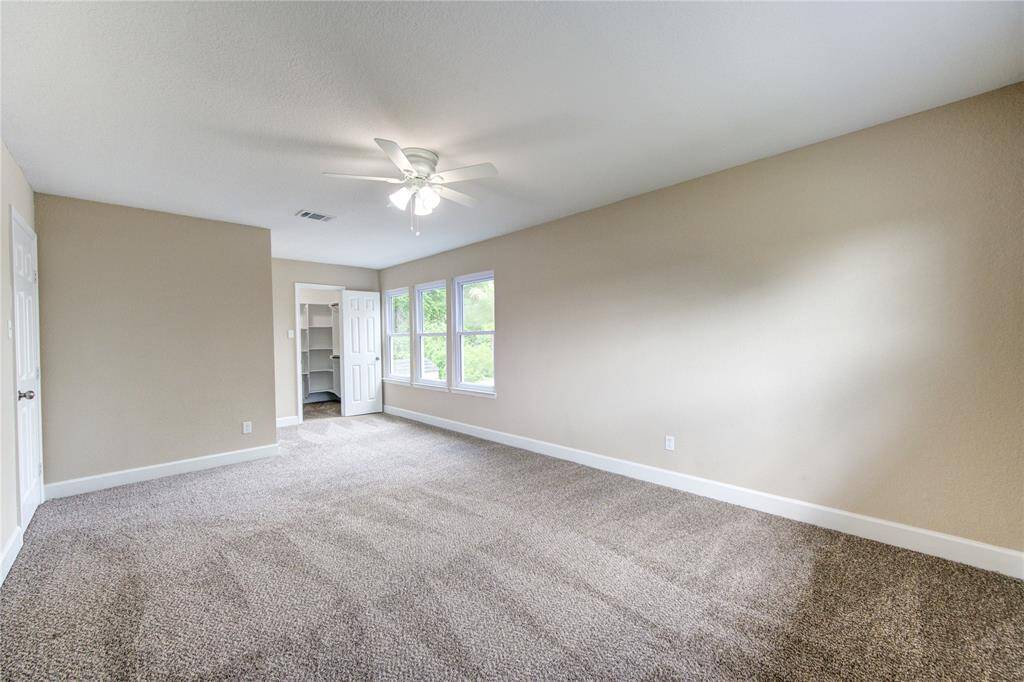 This is bedroom #3 - it's spacious, bright,  and includes a convenient walk-in closet with custom built shelving.