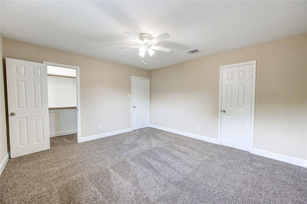 This is bedroom #4 - it's spacious, bright,  and includes a convenient walk-in closet with custom built shelving.